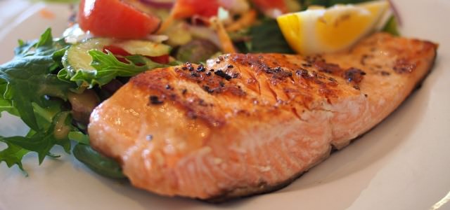 Plate of grilled salmon with assorted vegetables 